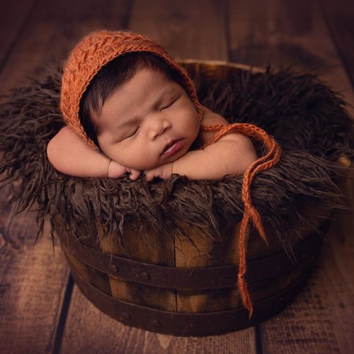 Photo of a newborn baby in a photo shoot.