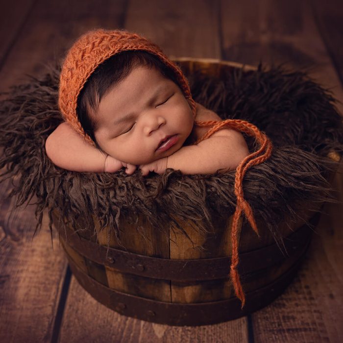 Photo of a newborn baby in a photo shoot.