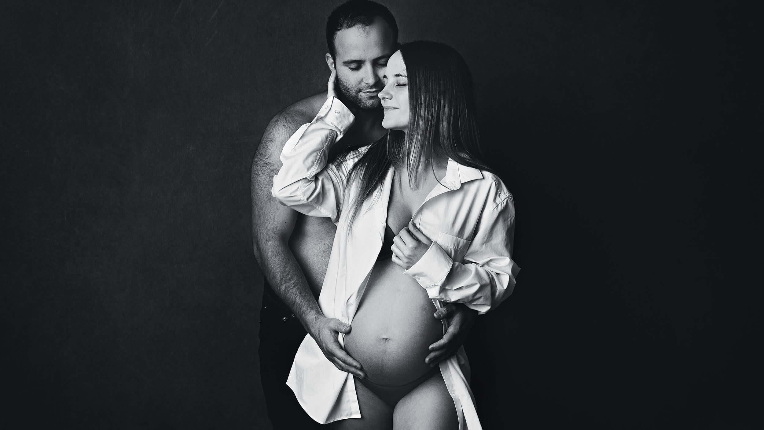 Couple in a posed maternity photo from a studio bump session with AnA Photography in Cornwall.